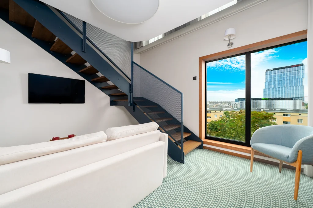 Duplex Deluxe with stairs to the mezzanine and a large window overlooking the city