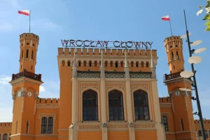 The neo-Gothic Wrocław Main Railway Station with turrets and rooftop lettering