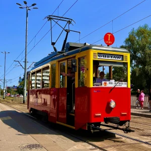 A historic red and yellow tram on tracks in Wrocław