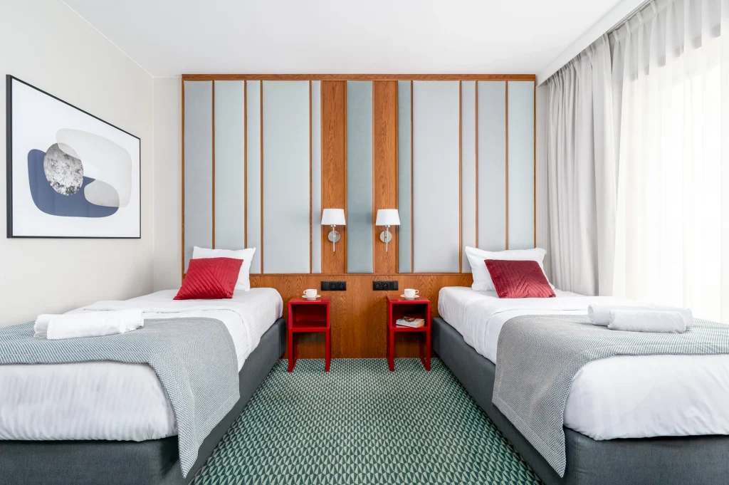 Superior Twin room with two single beds and red bedside tables