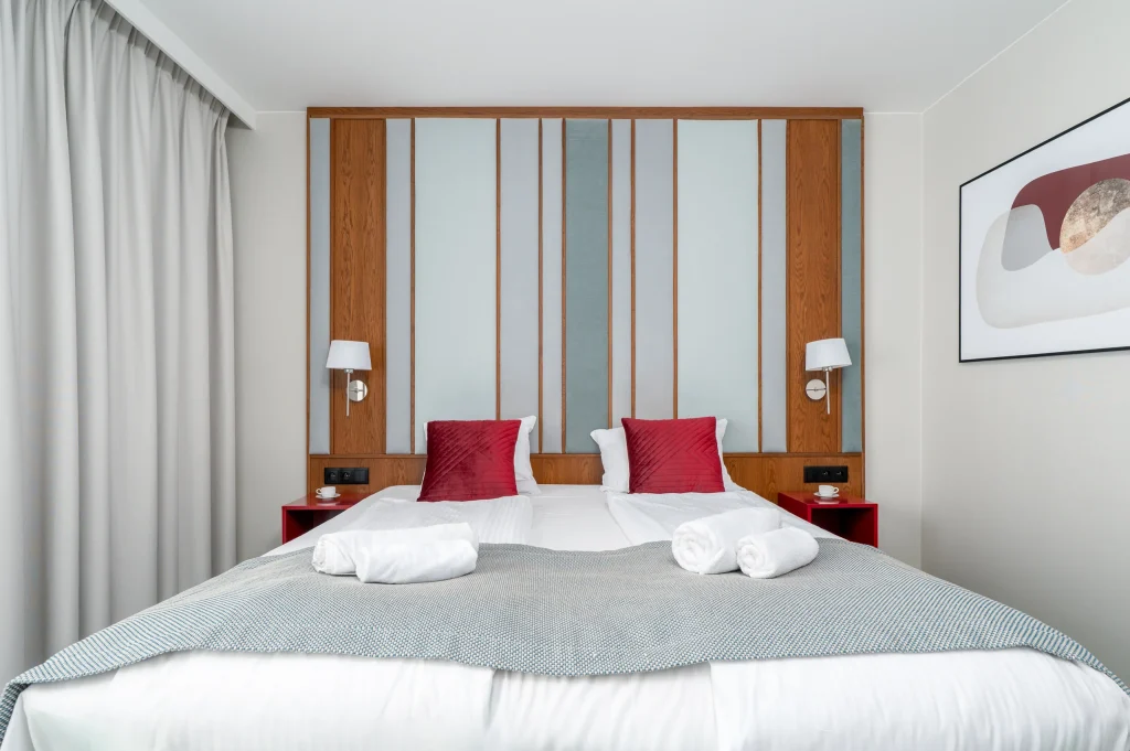 Bed headboard with wooden slats and wall lights