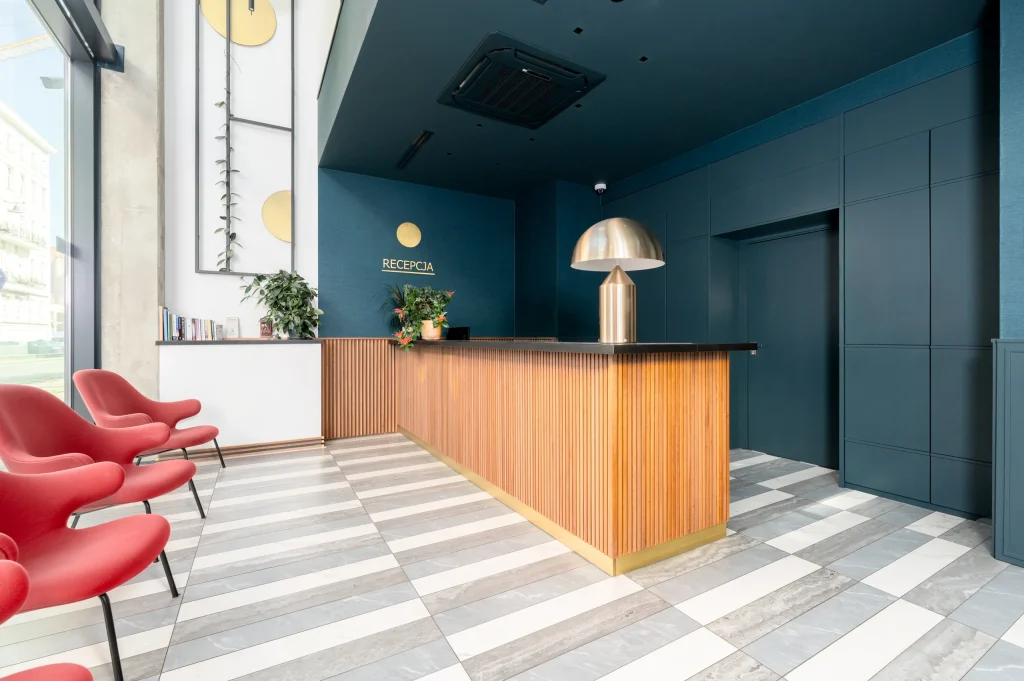Lobby with red armchairs and a reception desk